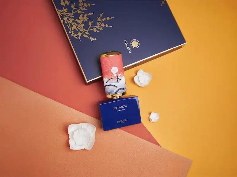 Navy blue gift box or packaging with delicate gold branch design on the cover.