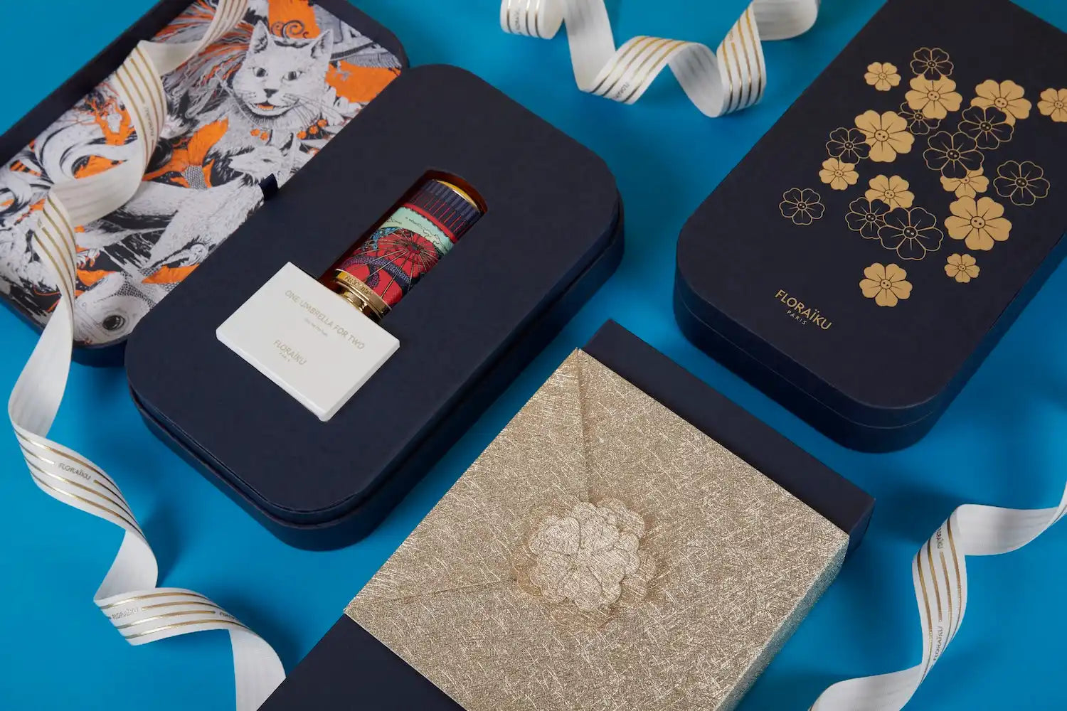 Navy blue gift boxes with decorative patterns and ribbons arranged on a surface.